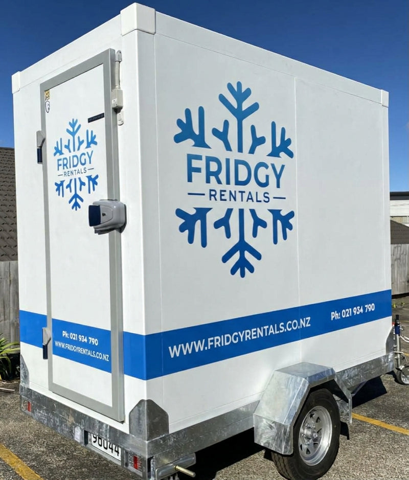 Large Fridgy Rentals trailer from the front corner, showing the walk-in door and snowflake logo
